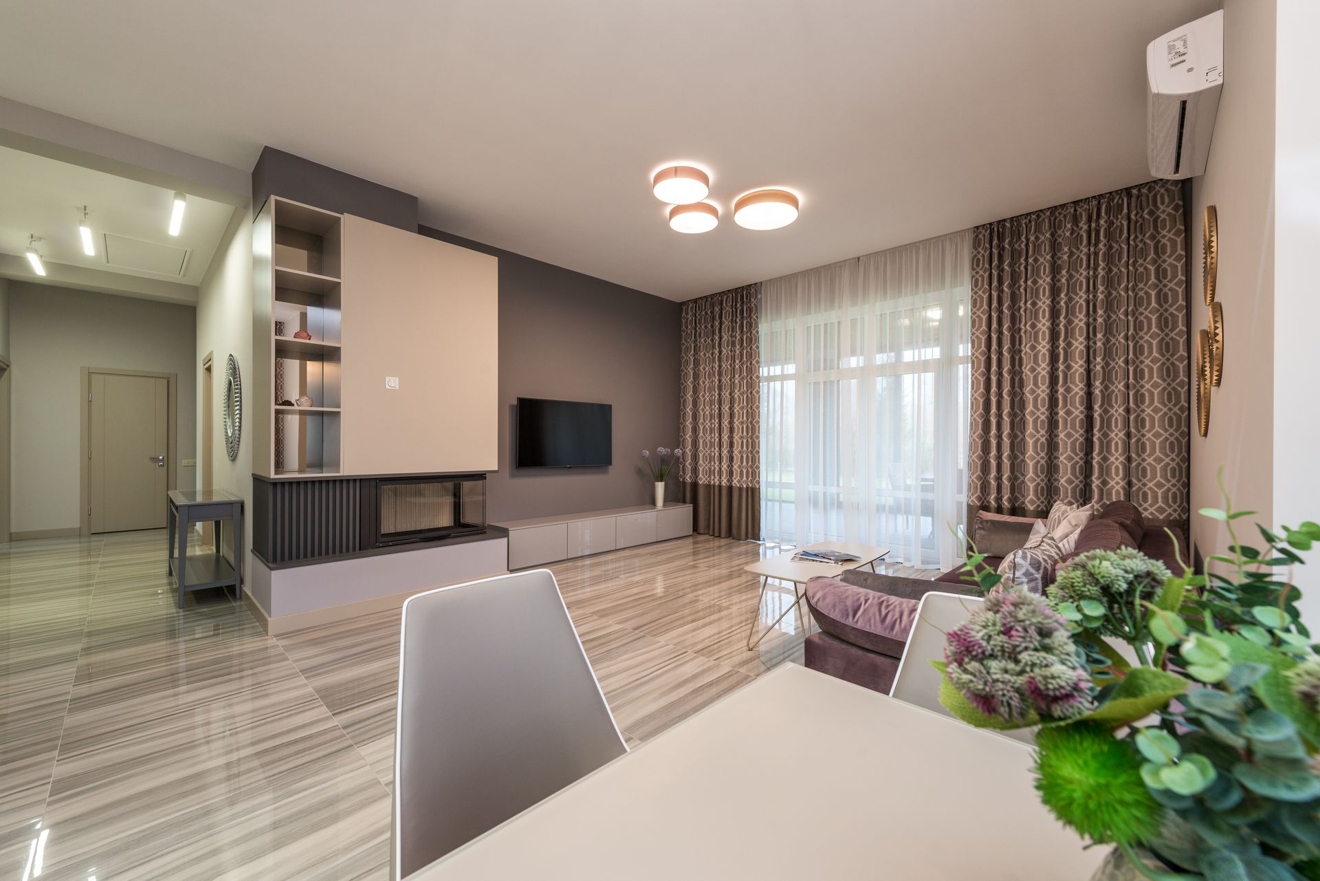 Bright, airy living room kept cool by a discreet wall-mounted air conditioning unit