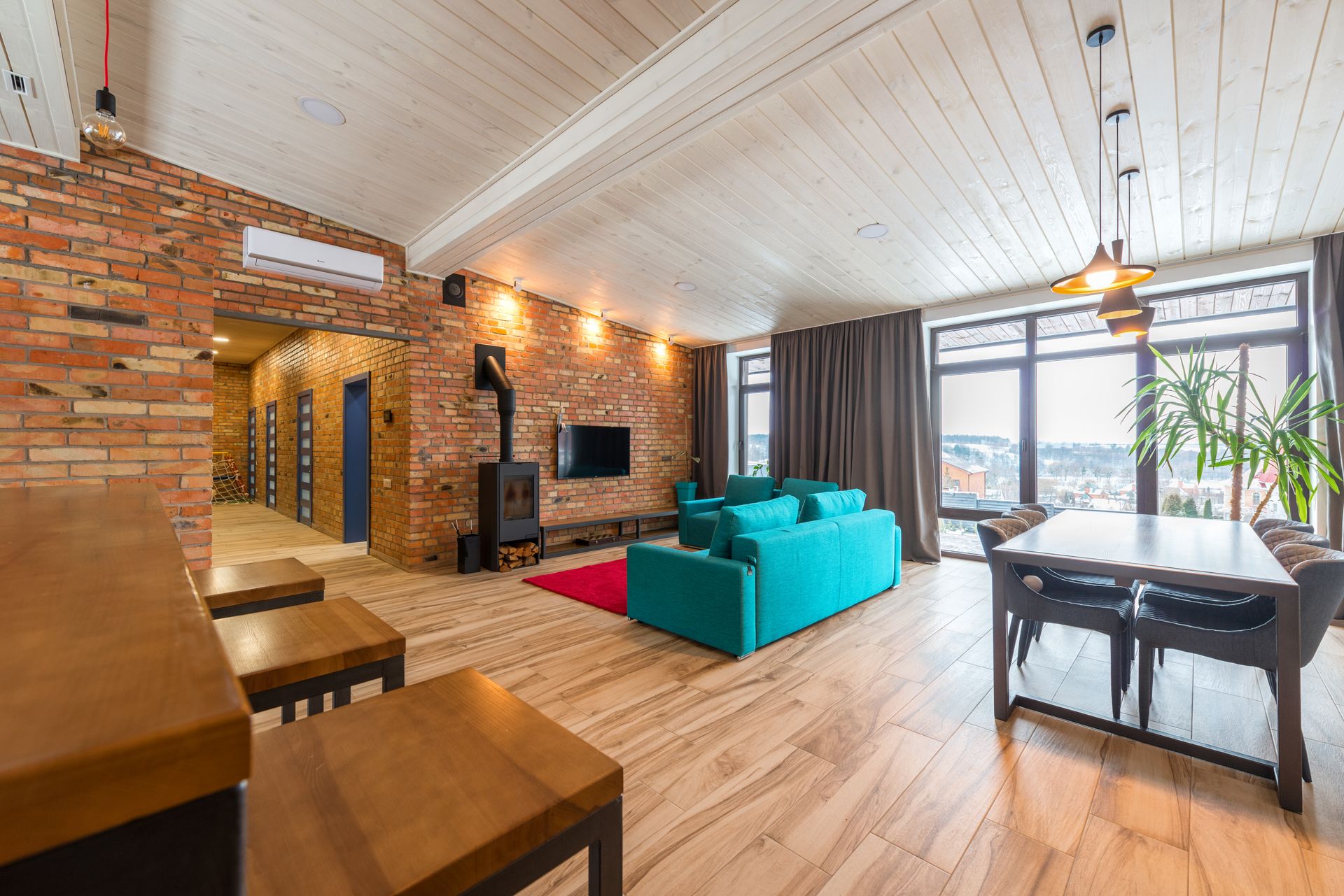 Air conditioning unit in a characterful open-plan living space with exposed brick