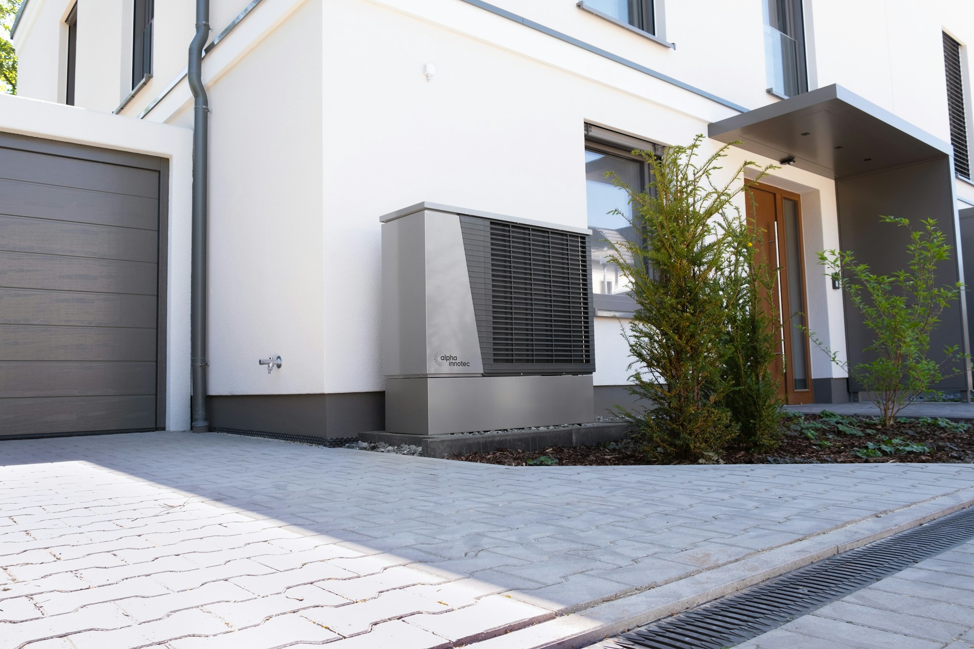 Outdoor heat pump unit installed neatly outside a modern home